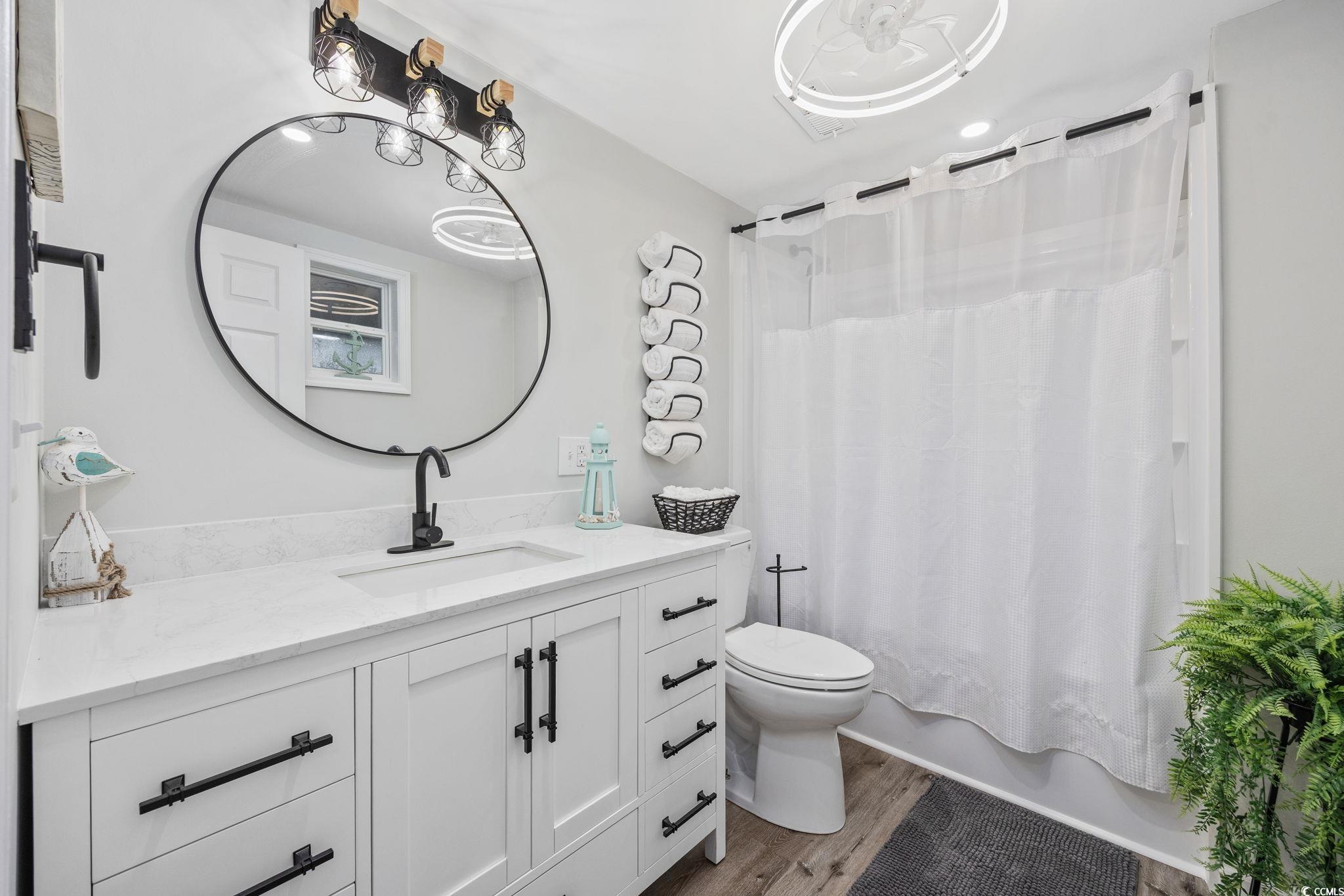 3118 State Rd S-26-816 Murrells Inlet, SC 29576 - Photo 15 of 40 Bathroom featuring vanity, shower / bath combo with shower curtain, and light wood-type flooring