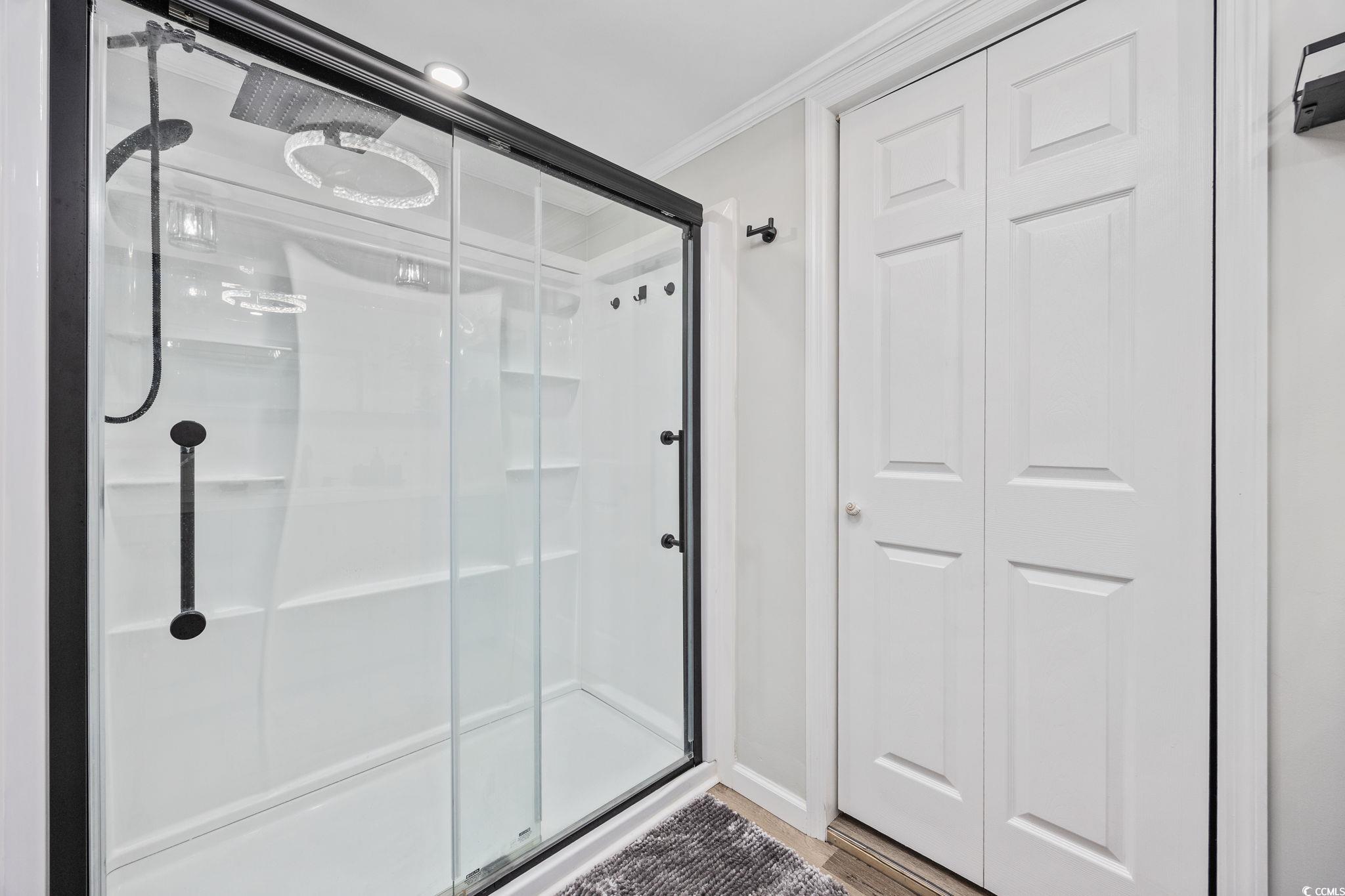 3118 State Rd S-26-816 Murrells Inlet, SC 29576 - Photo 20 of 40 Full bath with a shower stall, a closet, and crown molding