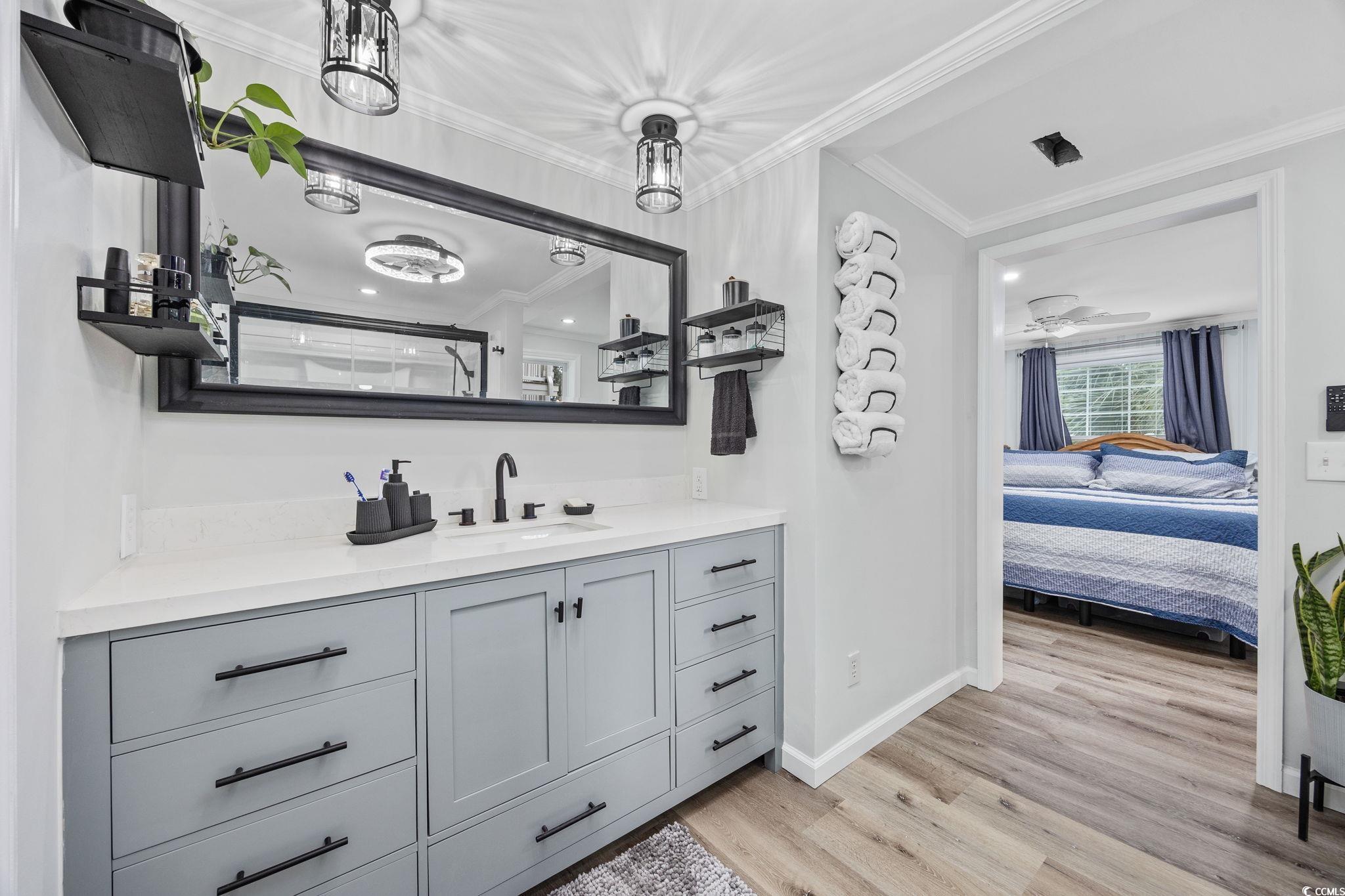 3118 State Rd S-26-816 Murrells Inlet, SC 29576 - Photo 21 of 40 Full bathroom featuring vanity, light wood-type flooring, ensuite bathroom, crown molding, and a shower