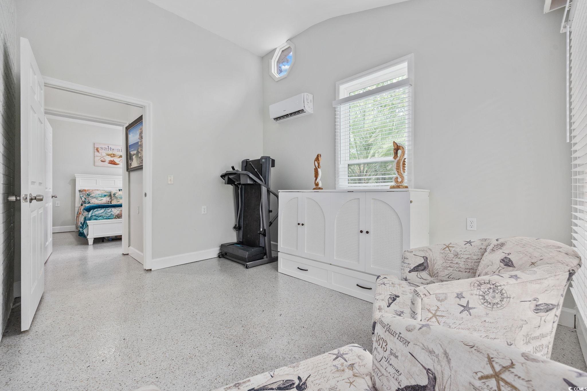 3118 State Rd S-26-816 Murrells Inlet, SC 29576 - Photo 25 of 40 Living area featuring dark aggregate flooring and a wall unit AC