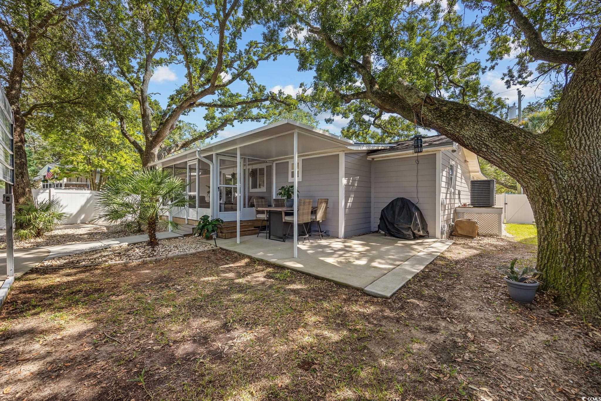 3118 State Rd S-26-816 Murrells Inlet, SC 29576 - Photo 29 of 40 Back of house featuring a sunroom and a patio