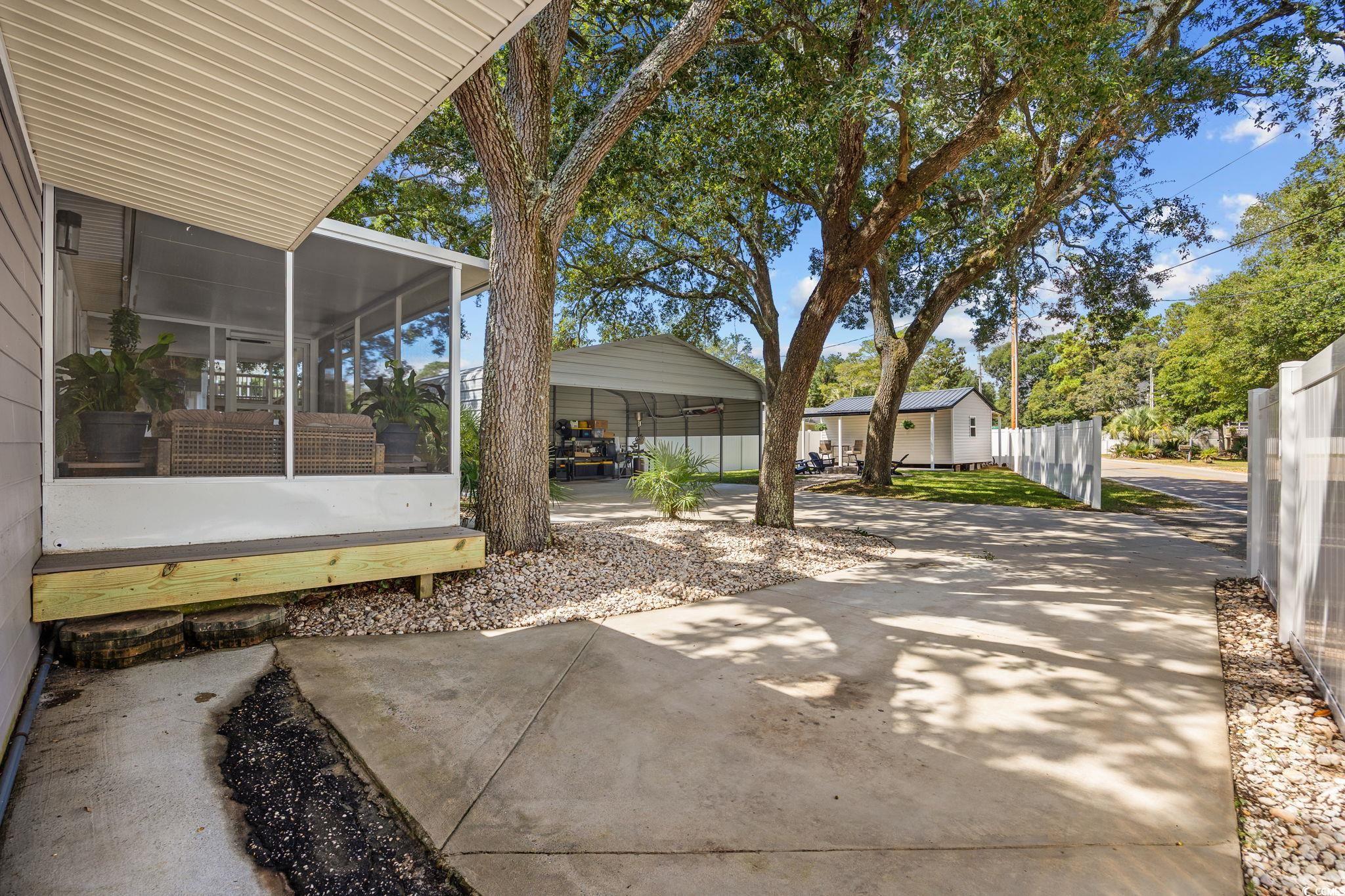 3118 State Rd S-26-816 Murrells Inlet, SC 29576 - Photo 30 of 40 View of patio / terrace with a sunroom and a detached carport