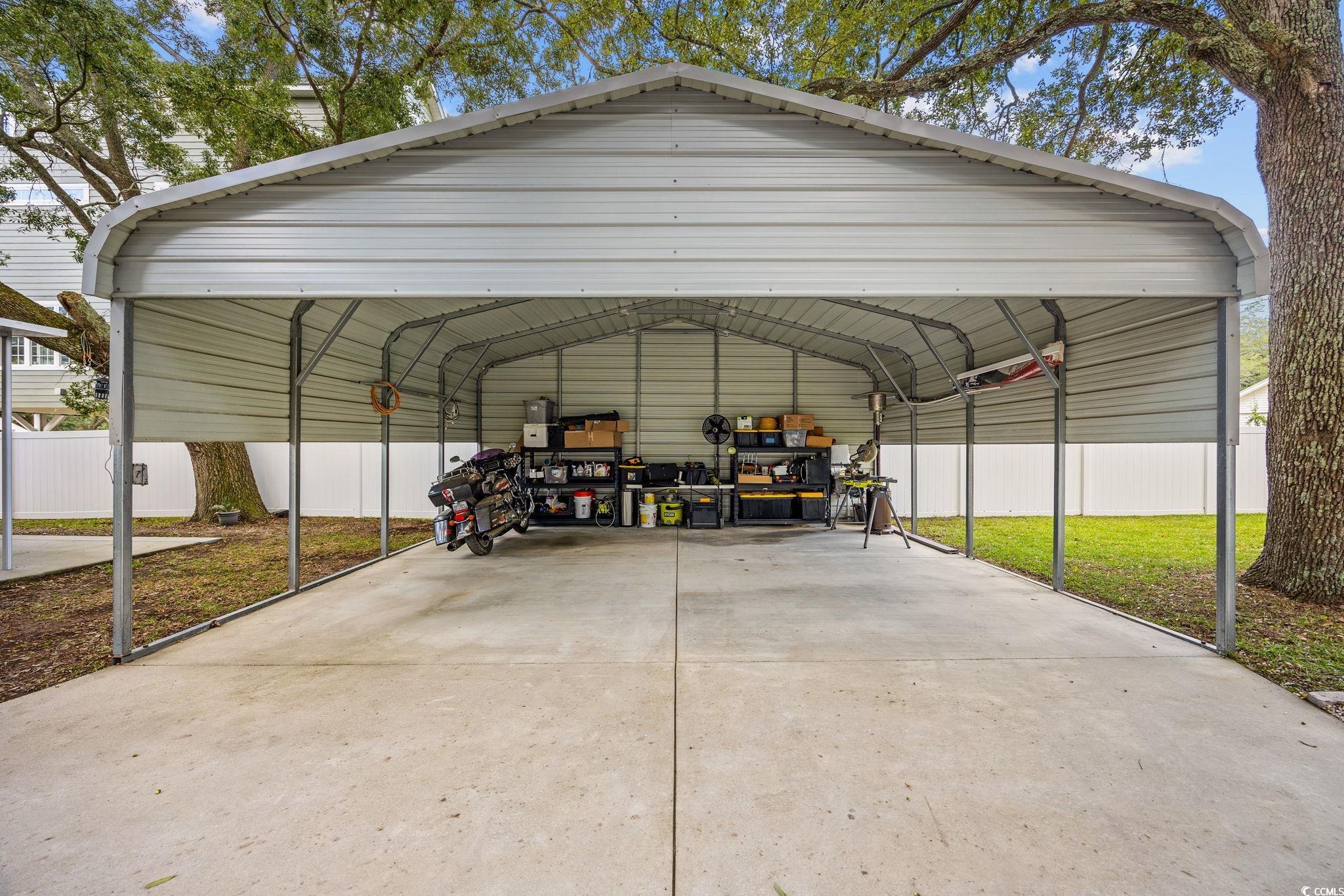 3118 State Rd S-26-816 Murrells Inlet, SC 29576 - Photo 34 of 40 View of vehicle parking featuring a detached carport
