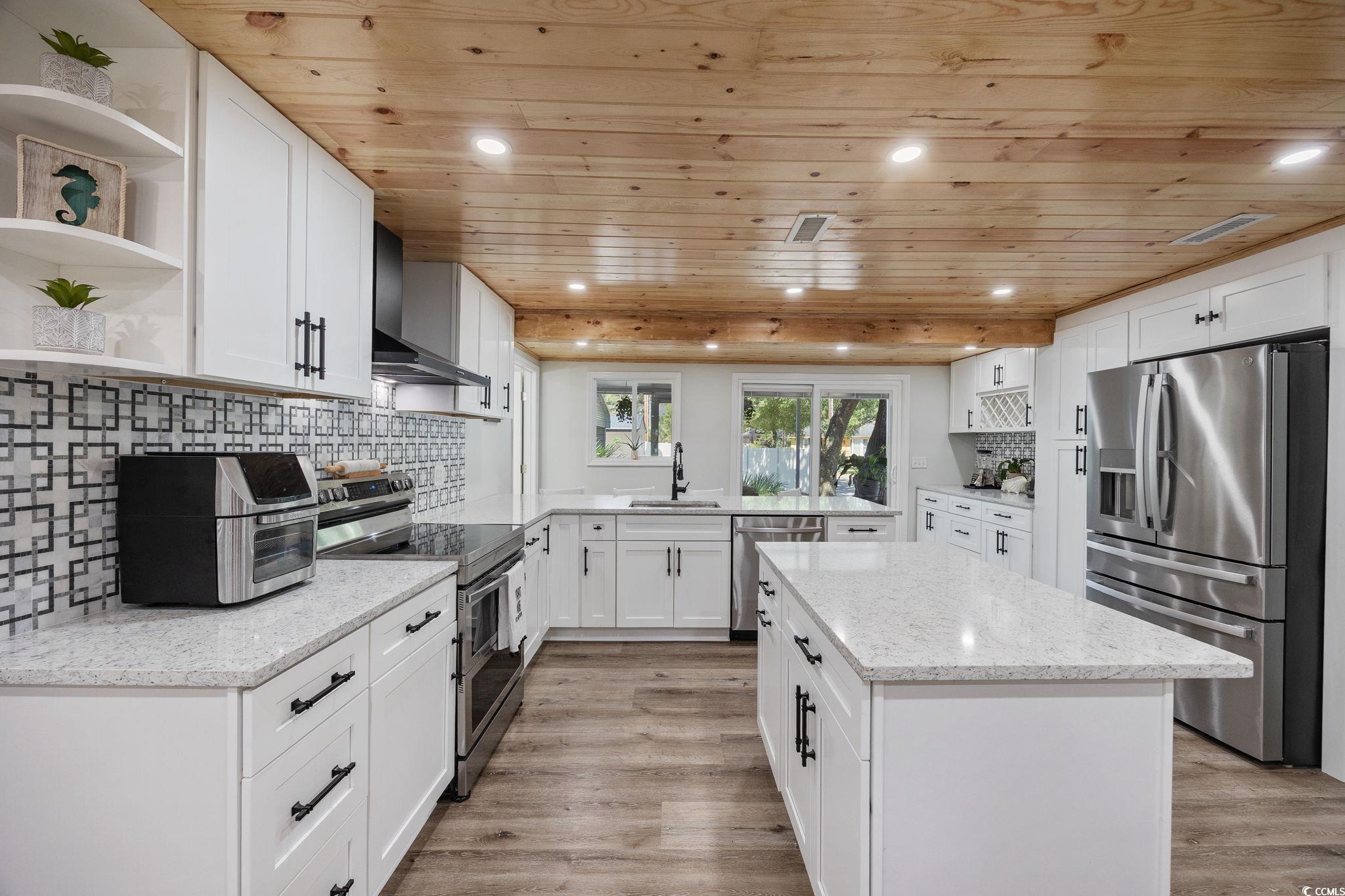 3118 State Rd S-26-816 Murrells Inlet, SC 29576 - Photo 8 of 40 Kitchen featuring wood ceiling, open shelves, backsplash, stainless steel appliances, and white cabinetry