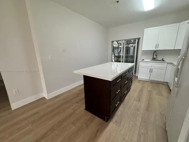 a kitchen with a cabinets and wooden floor