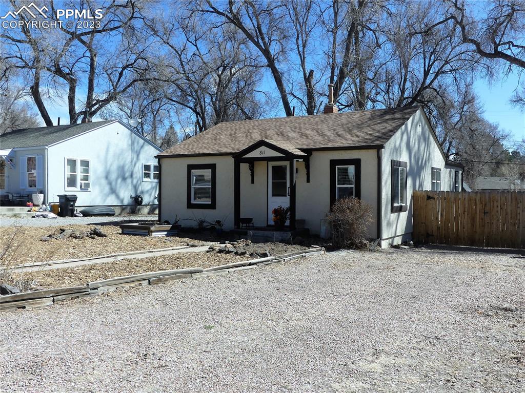 811 Prairie Road Colorado Springs, CO 80909 - Photo 2 of 34 a view of a house with a yard covered in snow