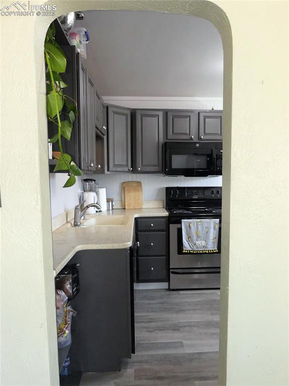811 Prairie Road Colorado Springs, CO 80909 - Photo 7 of 34 a kitchen with stainless steel appliances granite countertop a stove and a refrigerator