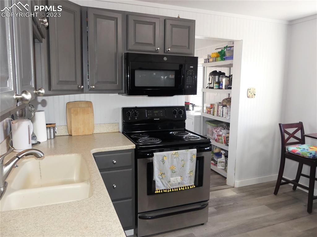 811 Prairie Road Colorado Springs, CO 80909 - Photo 9 of 34 a kitchen with granite countertop a stove top oven