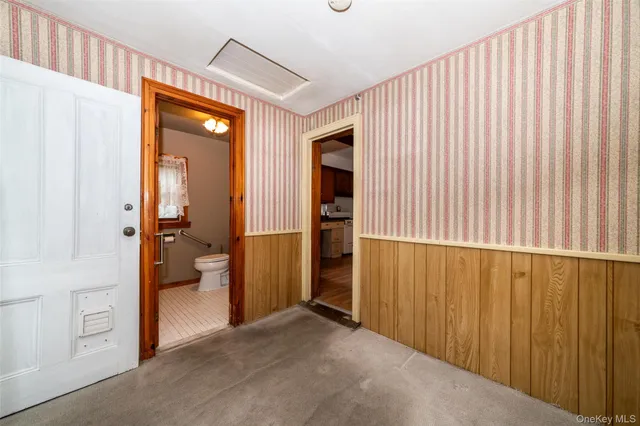 an empty room with closet and a chandelier fan