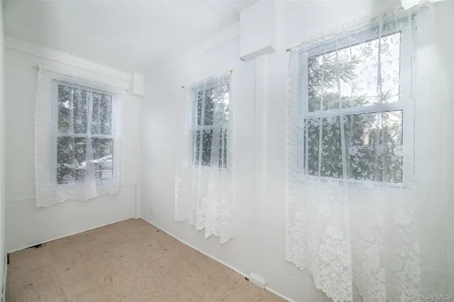 a view of entryway with wooden floor and walls