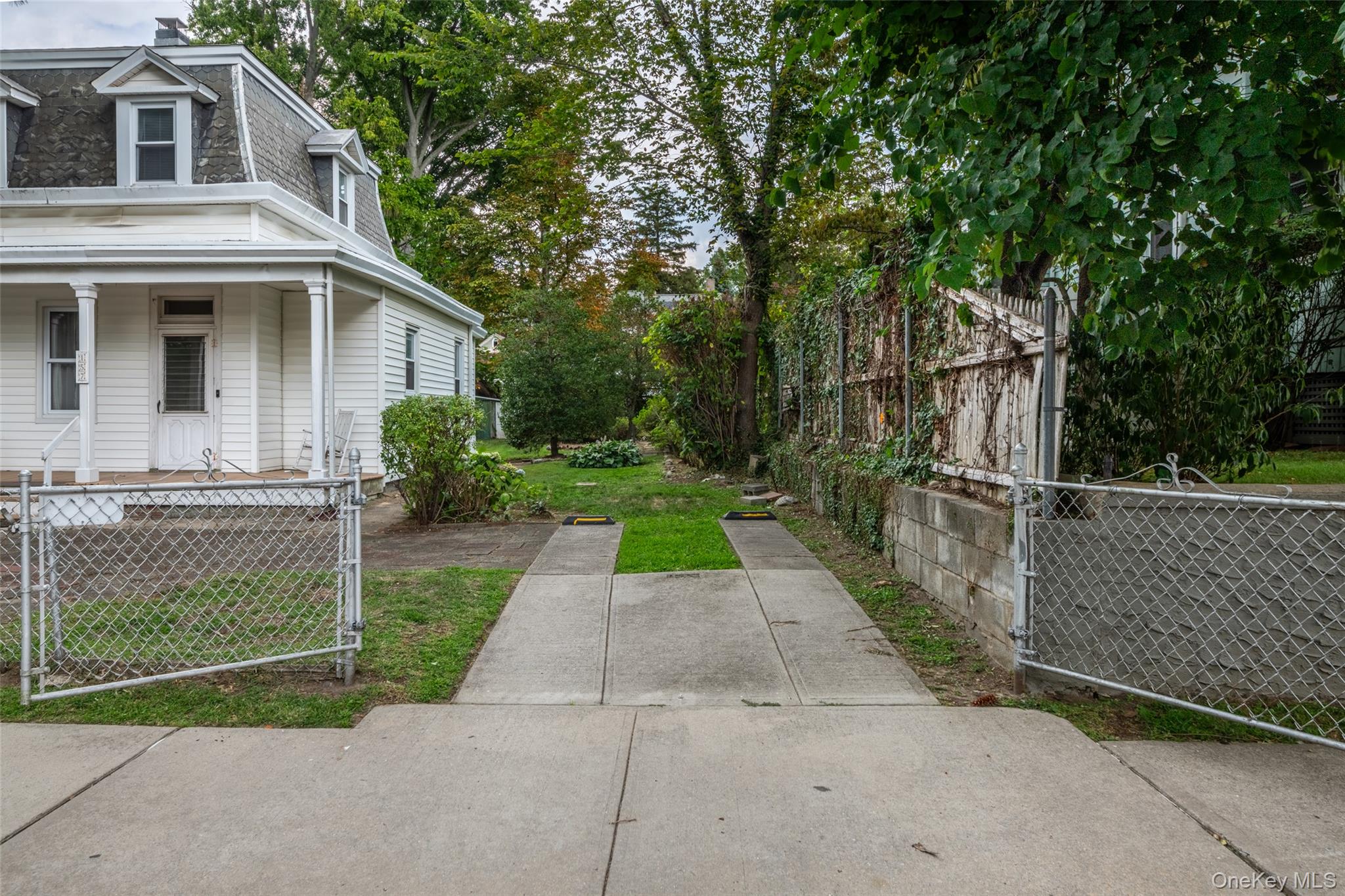 157 Schofield Street Bronx, NY 10464 - Photo 3 of 34 a front view of a house with a yard and garage