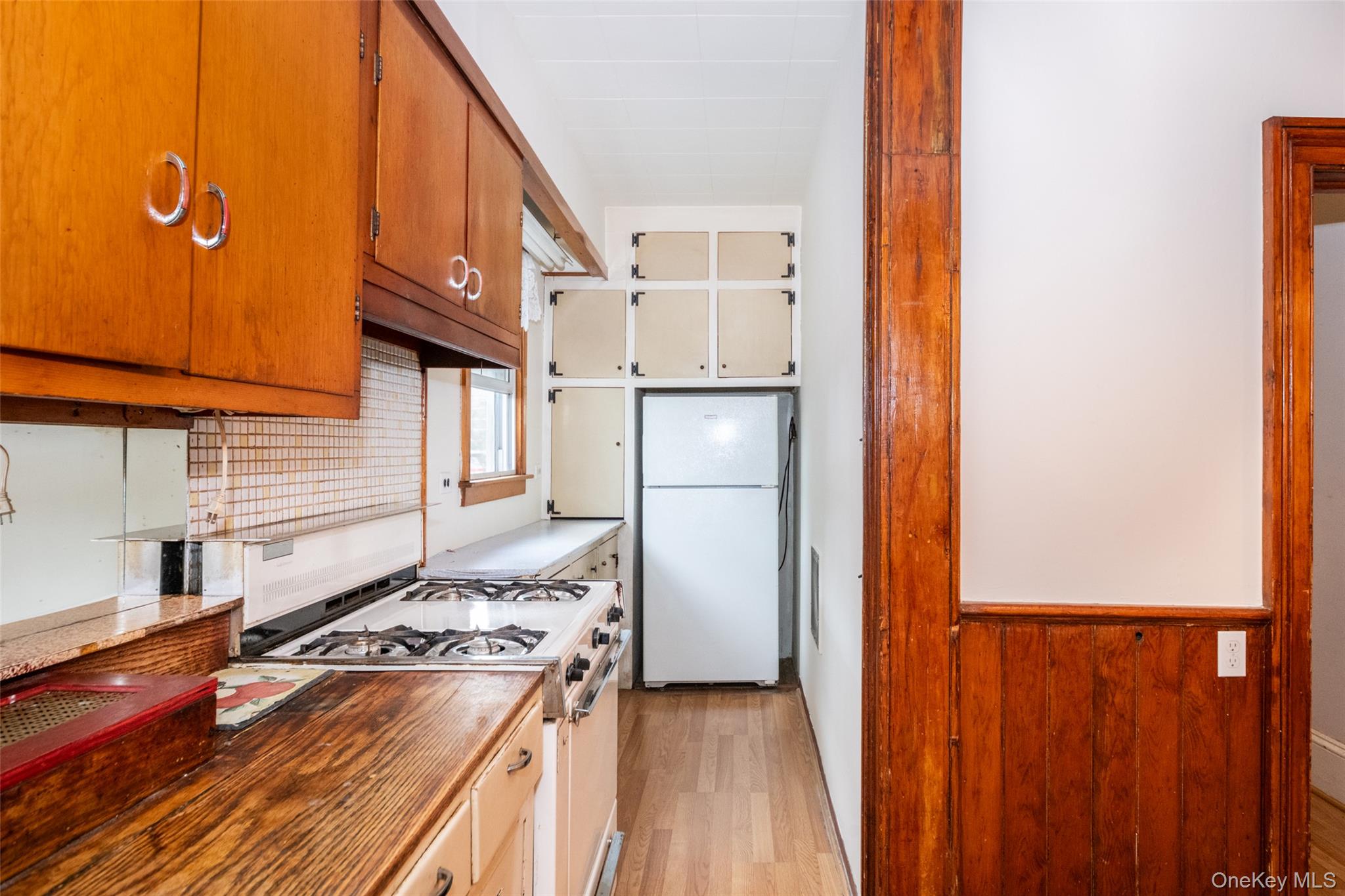 157 Schofield Street Bronx, NY 10464 - Photo 4 of 34 a kitchen with a refrigerator and a stove