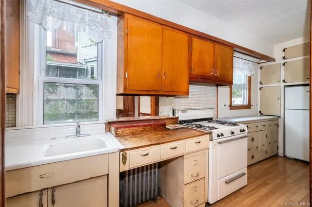 a kitchen with a stove a sink and a microwave