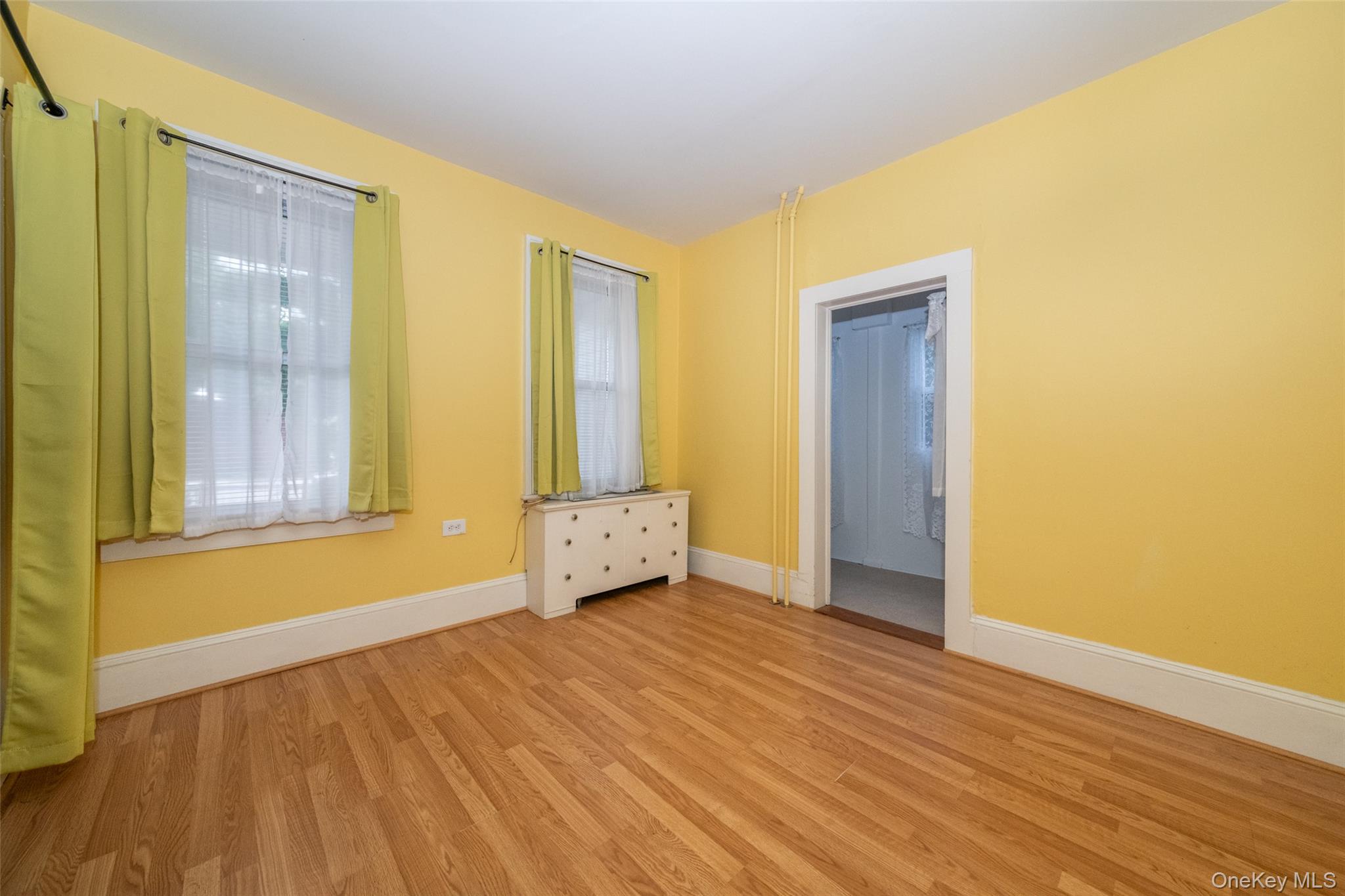 157 Schofield Street Bronx, NY 10464 - Photo 10 of 34 a view of an empty room with wooden floor and a window