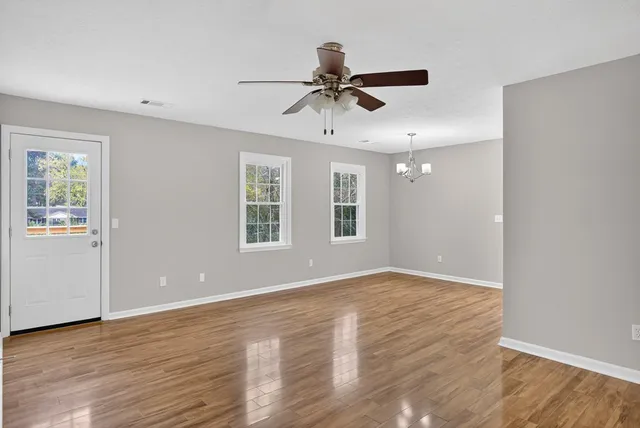 wooden floor in an empty room with a window