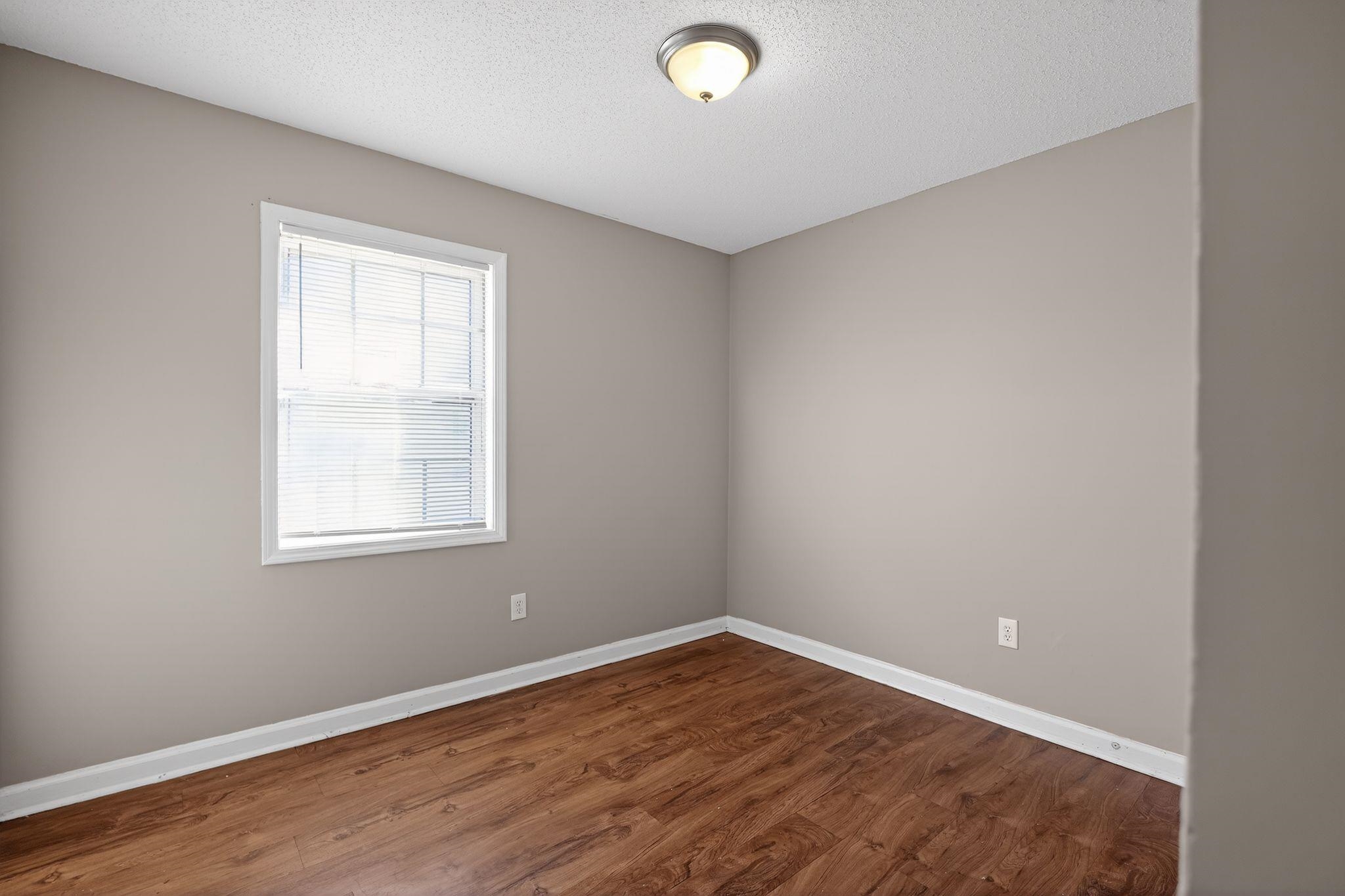 3637 Neely Road Memphis, TN 38109 - Photo 14 of 30 Spare room with a textured ceiling and wood finished floors