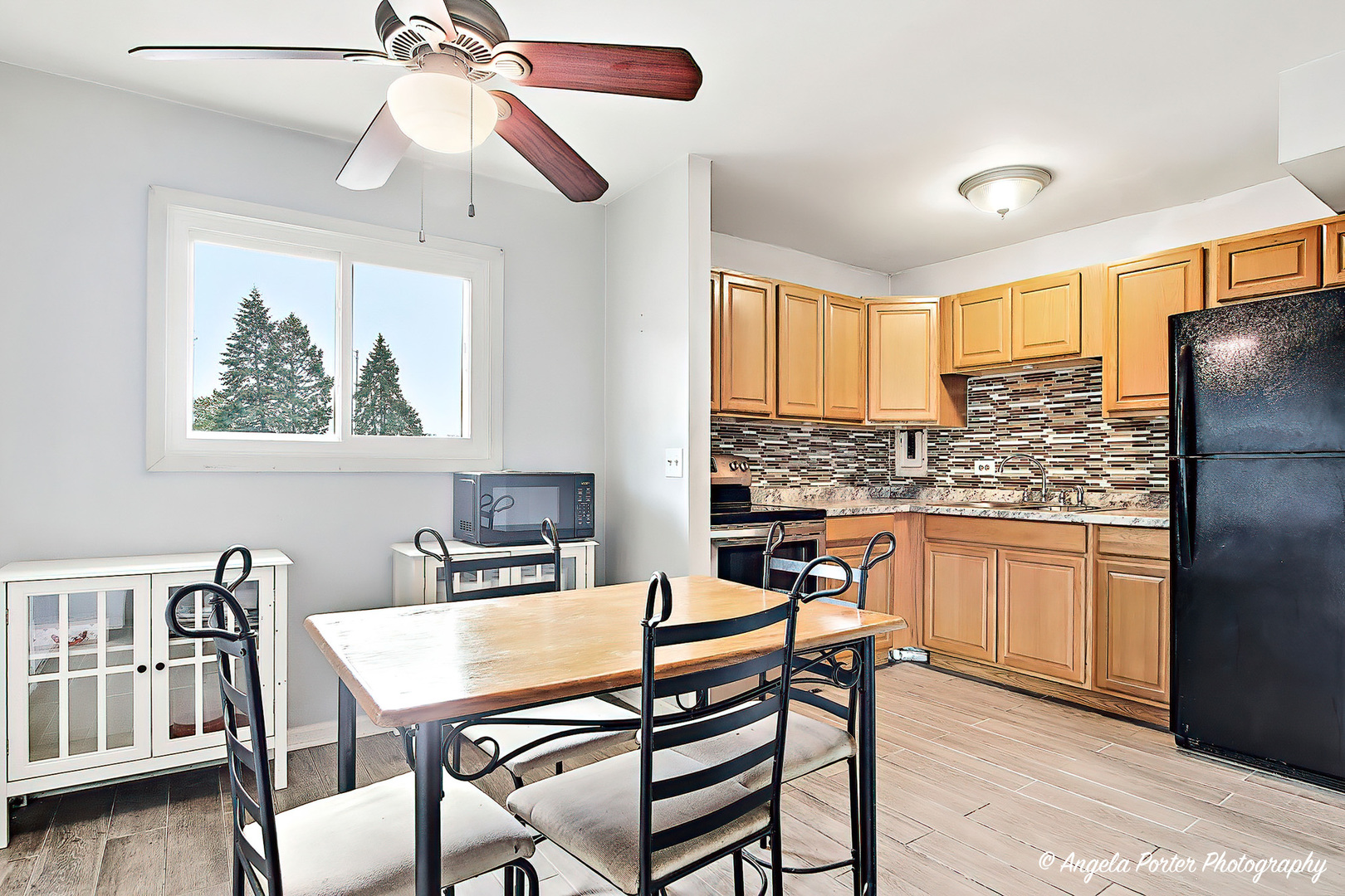 2504 West Algonquin Road, Unit 3 Rolling Meadows, IL 60008 - Photo 8 of 23 a view of a dining room with furniture window and wooden floor