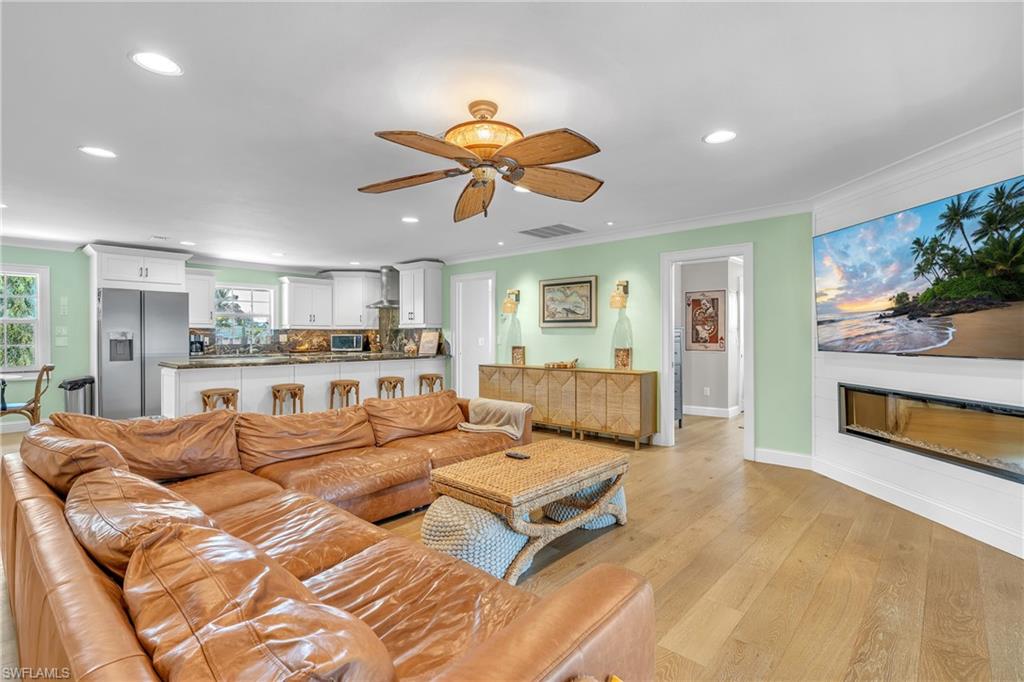 3001 50th Street Southwest Naples, FL 34116 - Photo 25 of 46 a living room with furniture a ceiling fan and a rug