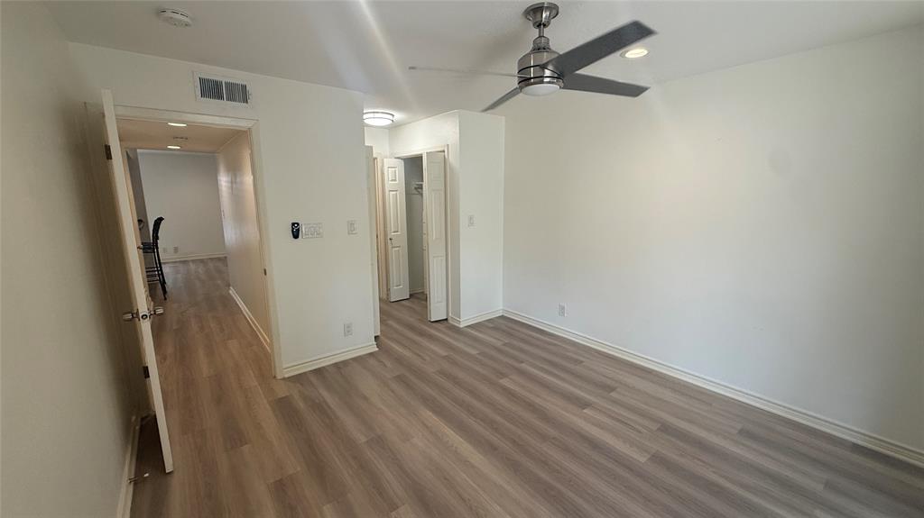 500 East Riverside Drive, Unit 132 Austin, TX 78704 - Photo 10 of 31 an empty room with wooden floor and a ceiling fan