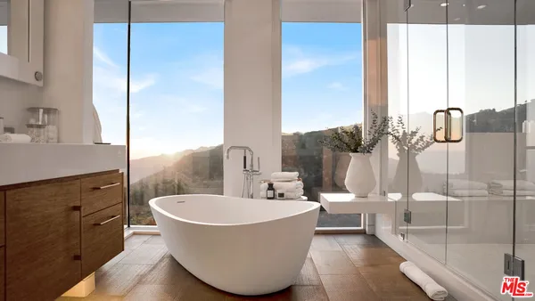 a spacious en suite bathroom with double vanity and a bathtub