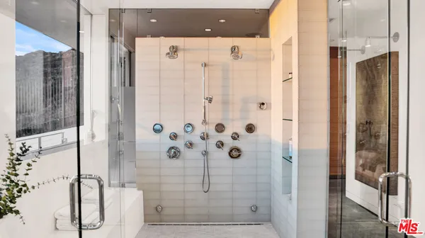 a bathroom with a tub sink and mirror