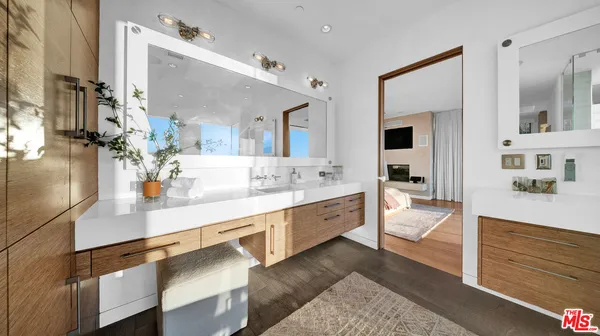 a bathroom with a sink a toilet and mirror