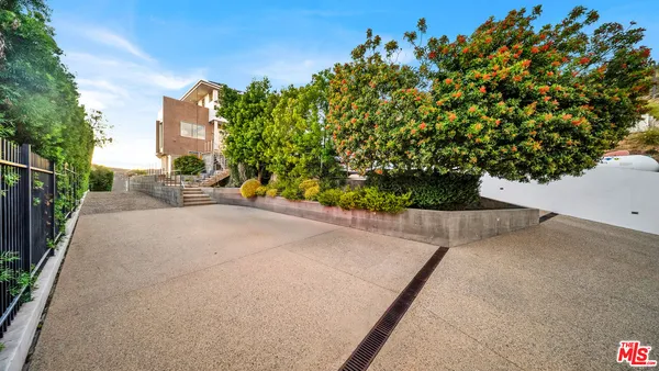 a front view of a house with stairs and a flat screen tv