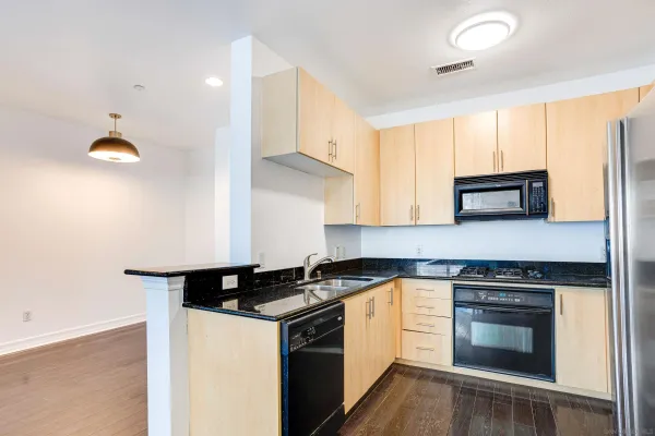 a kitchen with a sink and a stove top oven