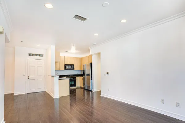 a view of a kitchen with a sink and a refrigerator
