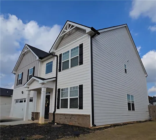 a view of a white house with many windows