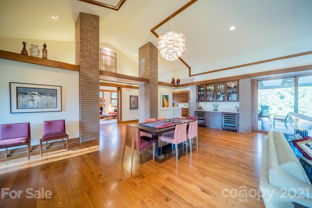2827 Rothwood Drive Charlotte, NC 28211 - Photo 11 of 30 a view of a dining room with furniture a chandelier and wooden floor
