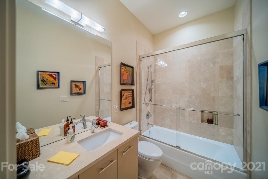 2827 Rothwood Drive Charlotte, NC 28211 - Photo 22 of 30 a bathroom with a sink mirror toilet and bathtub