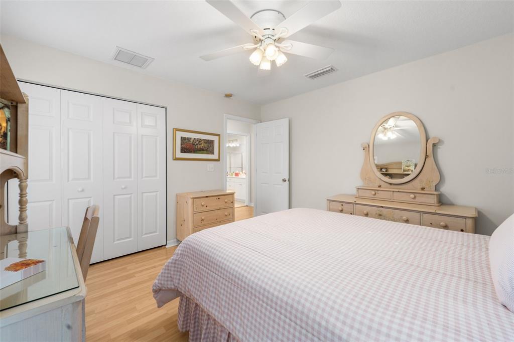 7418 White Oaks Road Alachua, FL 32615 - Photo 27 of 46 a bedroom with a bed a fireplace and a chandelier