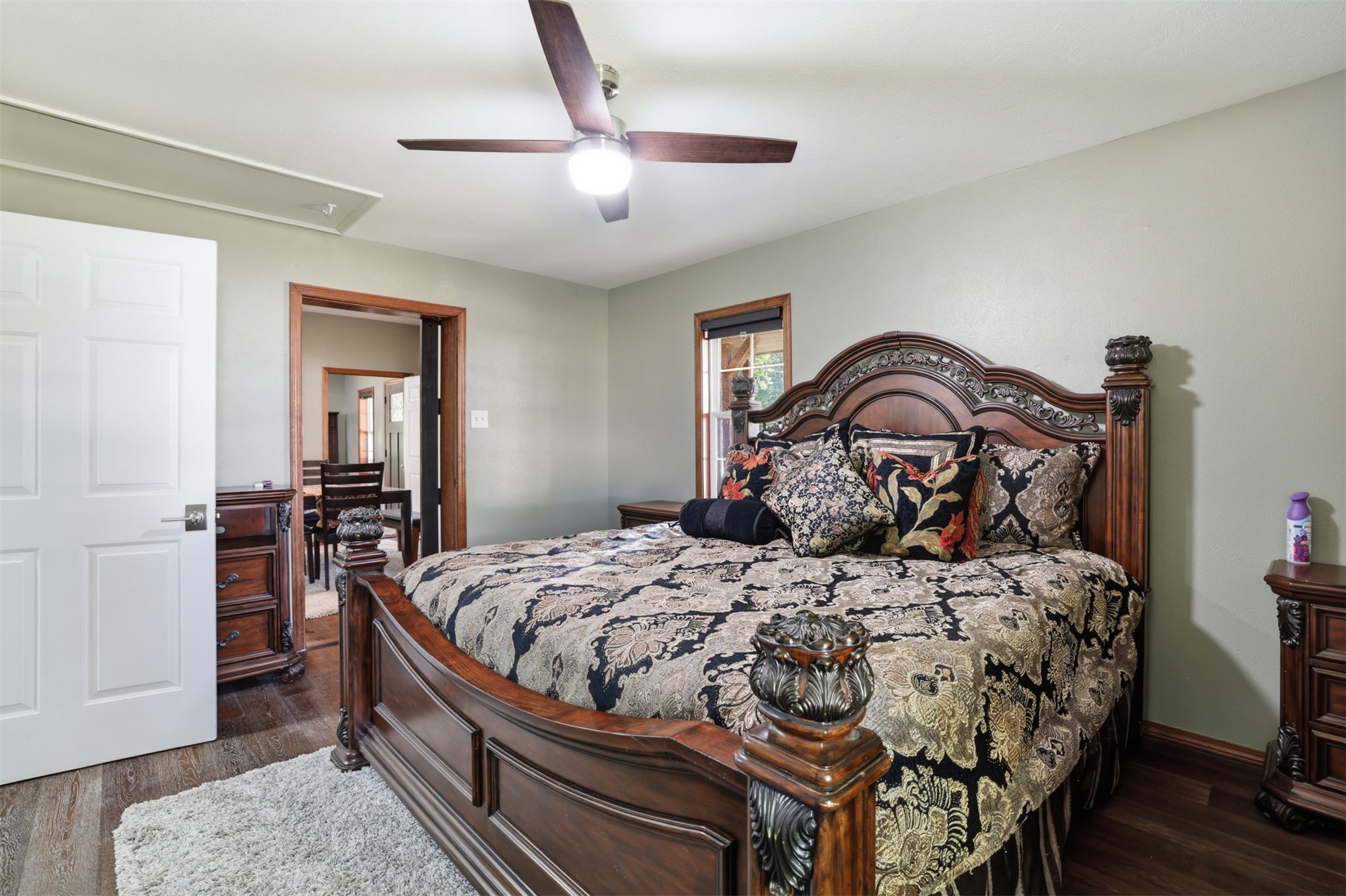 210 Main Caddo, OK 74729 - Photo 17 of 30 Spacious room featuring wood-finish flooring, a ceiling fan with integrated lighting, and a white six-panel door