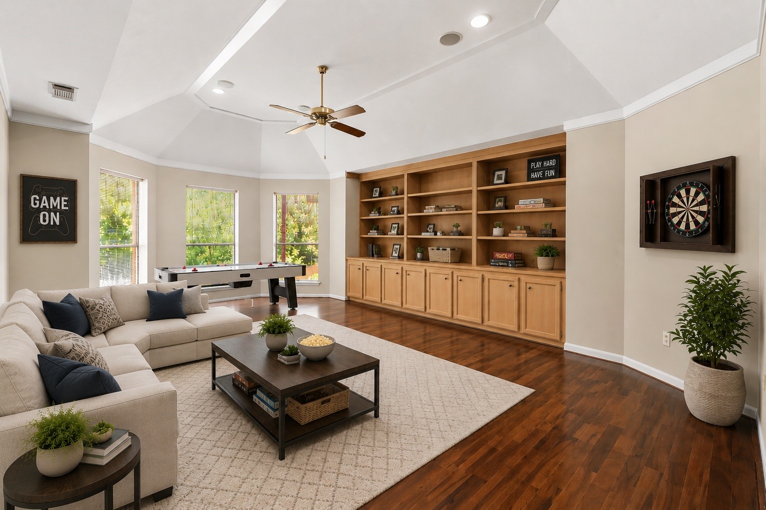18503 Cabaniss Circle Spring, TX 77379 - Photo 37 of 49 Upstairs, an expansive Game Room with vaulted ceilings, custom built-in cabinetry, and hardwood floors creates the perfect gathering space for movie nights, games, or entertaining. (virtually staged)