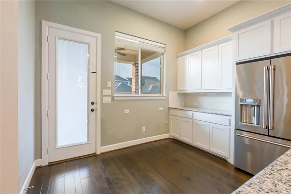a kitchen with stainless steel appliances granite countertop a refrigerator and a stove top oven