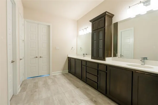 a bathroom with a sink a toilet and a mirror