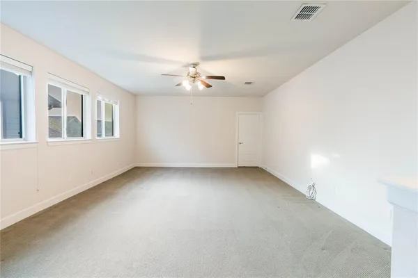 a view of an empty room with a kitchen