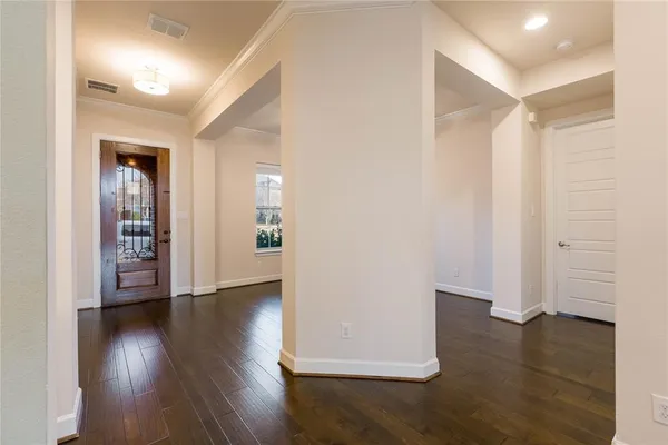 a view of a hallway with wooden floor