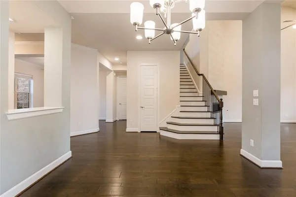 a view of entryway and hall with wooden floor