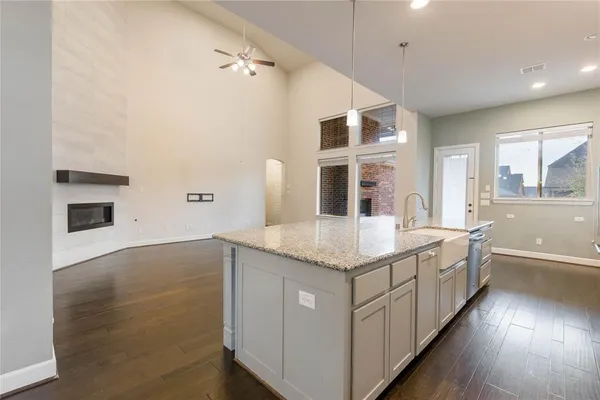 a bathroom with a granite countertop double vanity and a sink