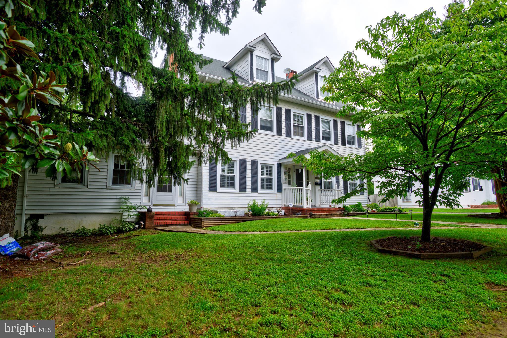 408 Hawthorne Road Linthicum Heights, MD 21090 - Photo 2 of 25 a front view of a house with a yard table and chairs