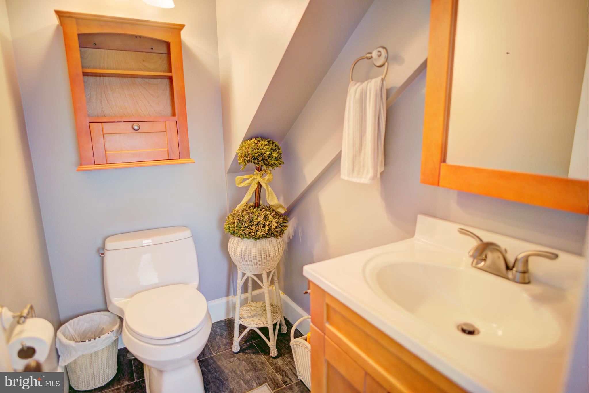 408 Hawthorne Road Linthicum Heights, MD 21090 - Photo 11 of 25 a bathroom with a toilet sink and mirror