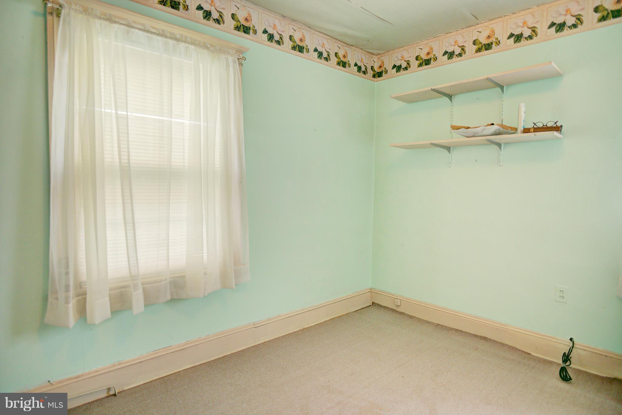 408 Hawthorne Road Linthicum Heights, MD 21090 - Photo 15 of 25 a view of a room with rack on the wall and a window