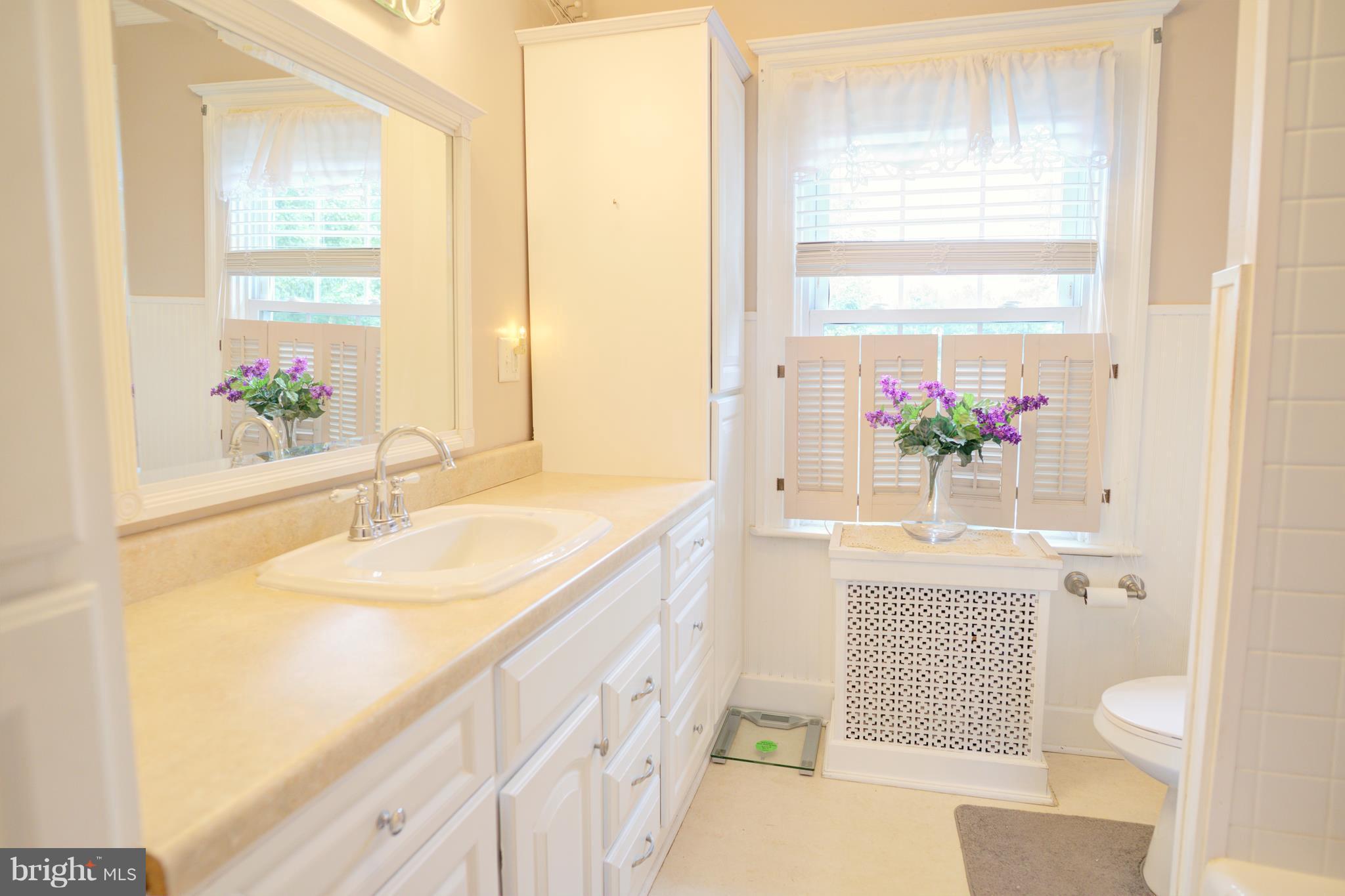 408 Hawthorne Road Linthicum Heights, MD 21090 - Photo 17 of 25 a bathroom with a sink a vanity and a mirror