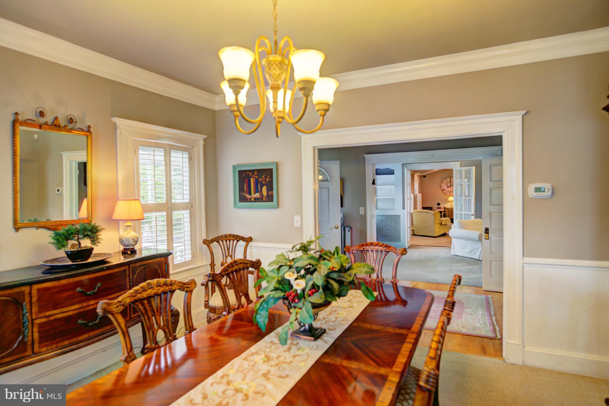 408 Hawthorne Road Linthicum Heights, MD 21090 - Photo 7 of 25 a view of a dining room with furniture a chandelier and wooden floor