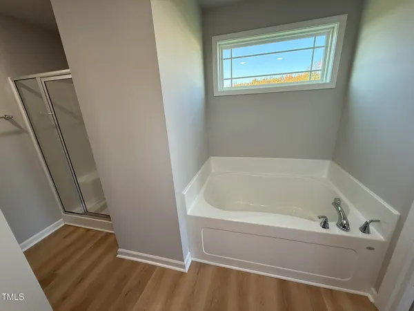 a bath tub sitting next to a white sink