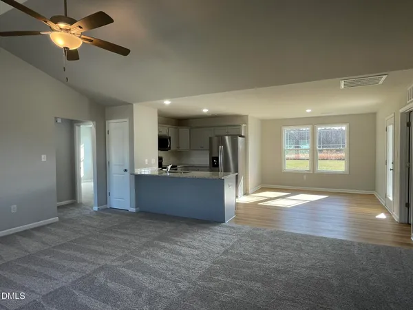 a view of large kitchen with a sink and a window