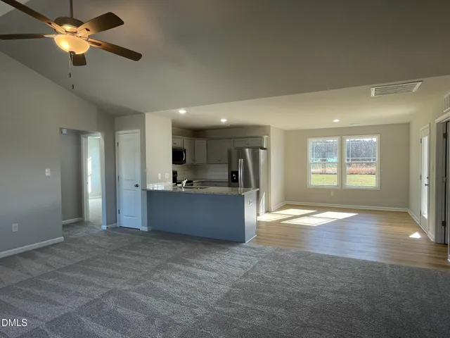 a view of large kitchen with a sink and a window