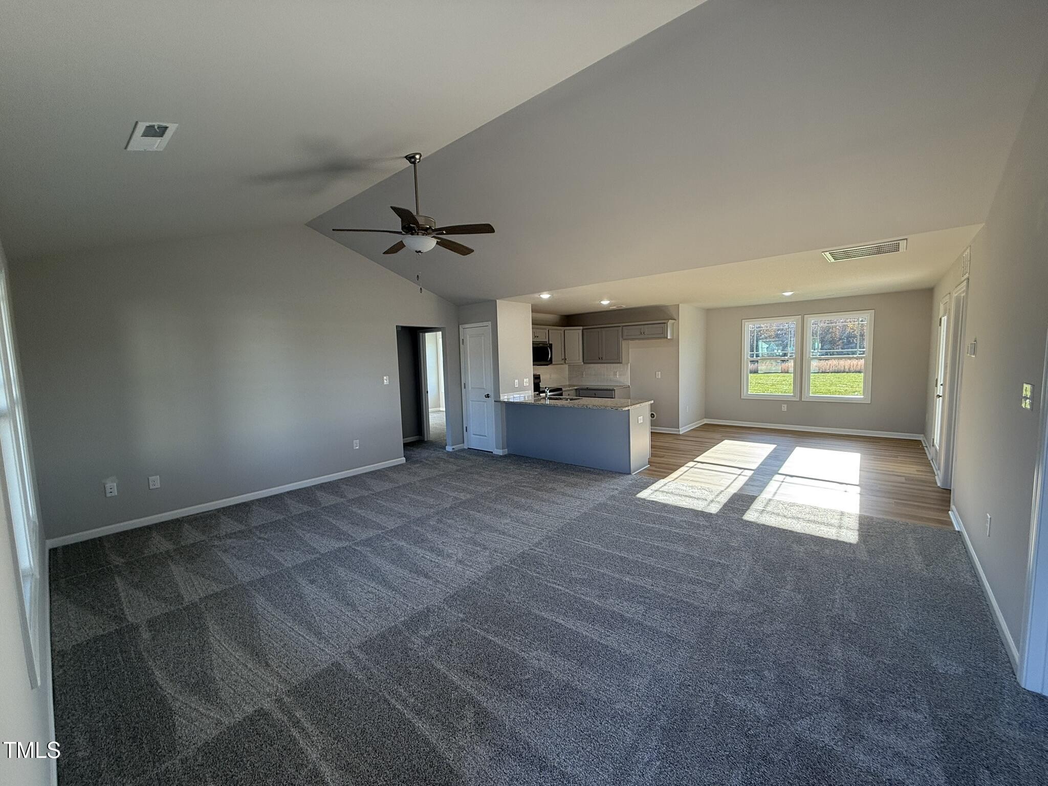 198 Pate Landing Drive Selma, NC 27576 - Photo 3 of 16 a view of an empty room and window and a kitchen